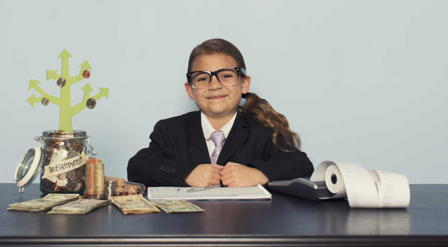 A smartly dressed child reads the news